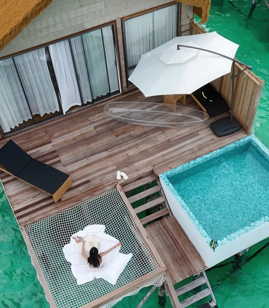 High angle drone shot of the overwater chalets Orange Wave Resort