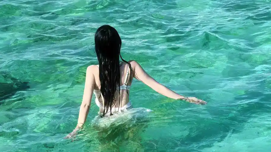 Guests enjoying swimming activities in the clear turquoise sea Orange Wave Resort